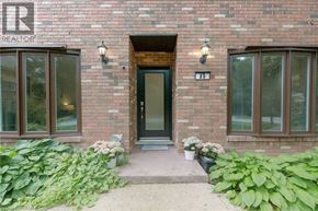 Ancaster house for rent - A brick building with a green door and windows.