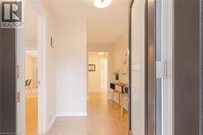 Ancaster house for rent - A hallway with a chair and a table in the distance.