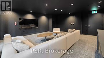 Toronto (Markland Wood) townhouse for rent - A modern living room with a grey carpet and a white sofa.