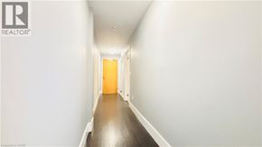 Kitchener condo for rent - A long hallway with a door at the end.