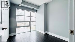 Kitchener condo for rent - A room with a sliding glass door leading outside.