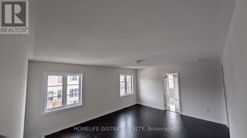 Clarington (Newcastle) duplex for rent - A room with a window overlooking a building.