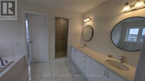 Clarington (Newcastle) duplex for rent - A bathroom with a sink, mirror, and toilet.