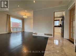 Toronto (Wexford-Maryvale) house for rent - A spacious living room with a large black table and a television in the corner.