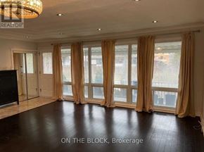 Toronto (Wexford-Maryvale) house for rent - A spacious room with a large window and a flat-screen TV.