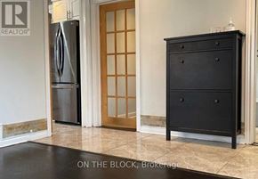 Toronto (Wexford-Maryvale) house for rent - A black chest of drawers sits in a kitchen with a tile floor.