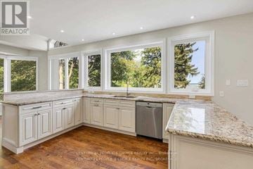 Oakville (Br Bronte) house for rent - A kitchen with white cabinets and a granite countertop.