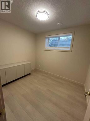 For rent in Calgary - A room with a window and a light on the ceiling.