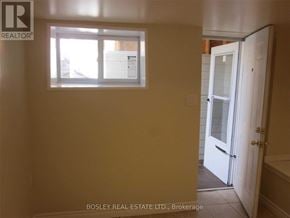 Toronto (Weston) triplex for rent - A room with a window and a door leading to a bathroom.