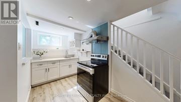 Vaughan (Uplands) house for rent - A kitchen with white cabinets and a wooden floor.