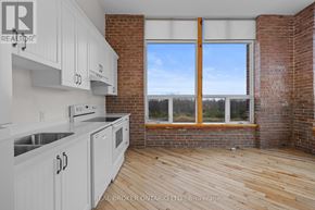 Carleton Place multi-family for rent - A kitchen with white cabinets and a wooden floor.