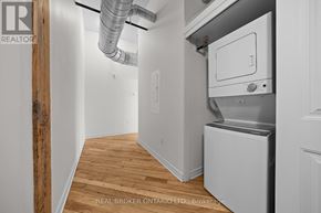 Carleton Place multi-family for rent - A room with a wood floor and a wall-mounted dryer.