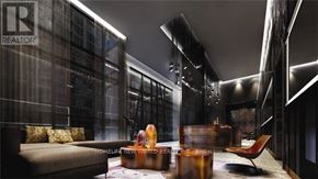 Toronto (Waterfront Communities) condo for rent - A modern living room with a glass wall and a brown sofa.