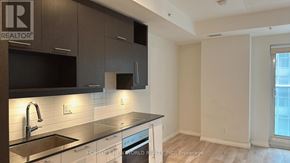 Toronto (Waterfront Communities) condo for rent - A kitchen with a sink, stove, and microwave.
