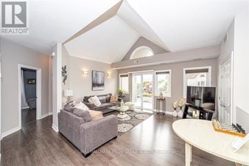 Ottawa townhouse for rent - A living room with a grey couch and a television.