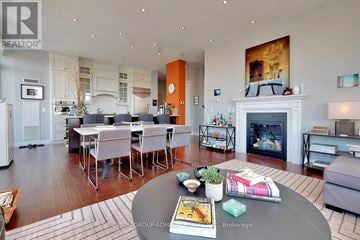 Toronto (Rosedale-Moore Park) condo for rent - A modern living room with a fireplace and a dining table set up.