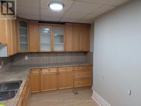 London East (East F) house for rent - A kitchen with wooden cabinets and a countertop.