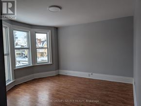 London East (East F) house for rent - A room with a window and wooden flooring.