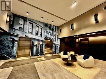 Markham (Unionville) condo for rent - A living room with a large painting on the wall and a couch.