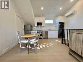 Vancouver house for rent - A kitchen with a table and chairs in the foreground and a refrigerator in the background.
