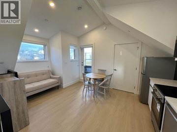 Vancouver house for rent - A well-lit, spacious living area with a dining table and chairs.