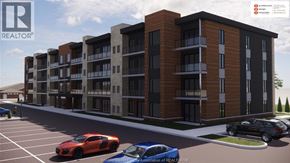 Windsor condo for rent - A rendering of a modern apartment complex with cars parked in the foreground.