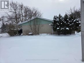 London North (North H) house for rent - A snow-covered ground with a building in the background.