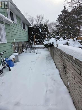 London North (North H) house for rent - A green house with a snow covered yard.