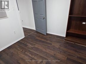 London North (North H) house for rent - A room with a wooden floor and a grey door.