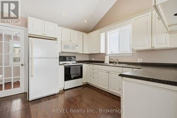 Thorold (Rolling Meadows) house for rent - A kitchen with white cabinets and appliances is on the market with REVEL Realty Inc.