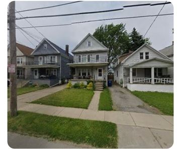 Buffalo apartment for rent - A row of houses with a blue house on the left and a white house on the right.