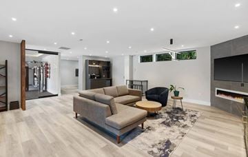 Anderson apartment for rent - A modern living room with a grey sofa set and a black chair.