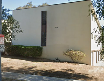Pasadena apartment for rent - A small white building with a brown door and a small tree in front.