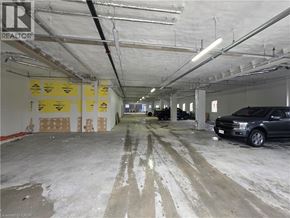 Woodstock apartment for rent - A large, empty garage with a car parked on the right side.