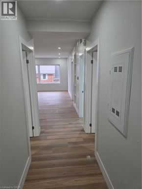 Woodstock apartment for rent - A long hallway with wood floors and white walls.