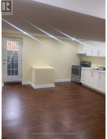 Brampton (Northwest Brampton) house for rent - A kitchen with white cabinets and a wooden floor.