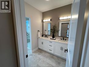 Windsor apartment for rent - A bathroom with a sink, mirror, and cabinets.