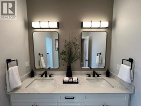 Windsor apartment for rent - A bathroom with a large mirror above a sink.