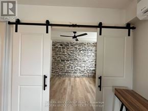 North Grenville multi-family for rent - A room with a sliding door and a ceiling fan.