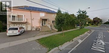 Toronto (Bathurst Manor) house for rent - A kitchen with white cabinets and a black stove top oven.