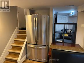 Toronto (Bathurst Manor) house for rent - A kitchen with white cabinets and a marble countertop.