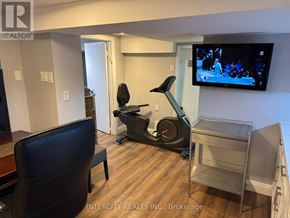 Toronto (Bathurst Manor) house for rent - A kitchen with a wooden table and a refrigerator.