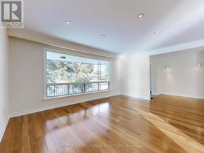 Vaughan (Crestwood-Springfarm-Yorkhill) house for rent - A spacious room with wooden flooring and a large window overlooking a balcony.