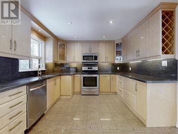 Vaughan (Crestwood-Springfarm-Yorkhill) house for rent - A kitchen with wooden cabinets and granite countertops.