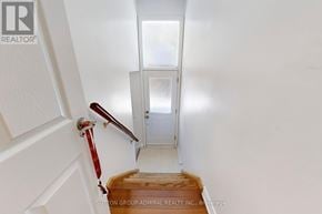 Vaughan (Crestwood-Springfarm-Yorkhill) house for rent - A stairway with a red handrail and wooden steps leading to a white door.