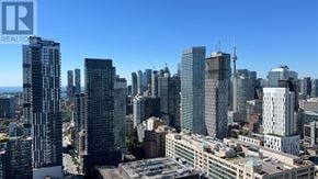 Toronto (Church-Yonge Corridor) condo for rent - A cityscape with tall buildings and a clear sky.