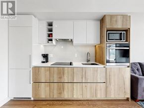 Toronto (Church-Yonge Corridor) condo for rent - A white bedroom with a doorway leading to another room.
