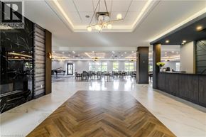 Brantford apartment for rent - A spacious office lobby with a wooden floor and a reception desk.