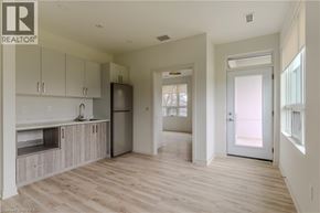 Brantford apartment for rent - A well-lit, spacious kitchen with wooden floors and white walls.