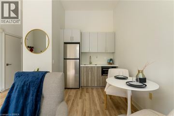Brantford apartment for rent - A modern kitchen with a dining table and chairs.